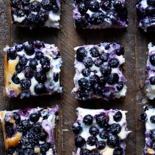 blueberry cheesecake squares on wooden background