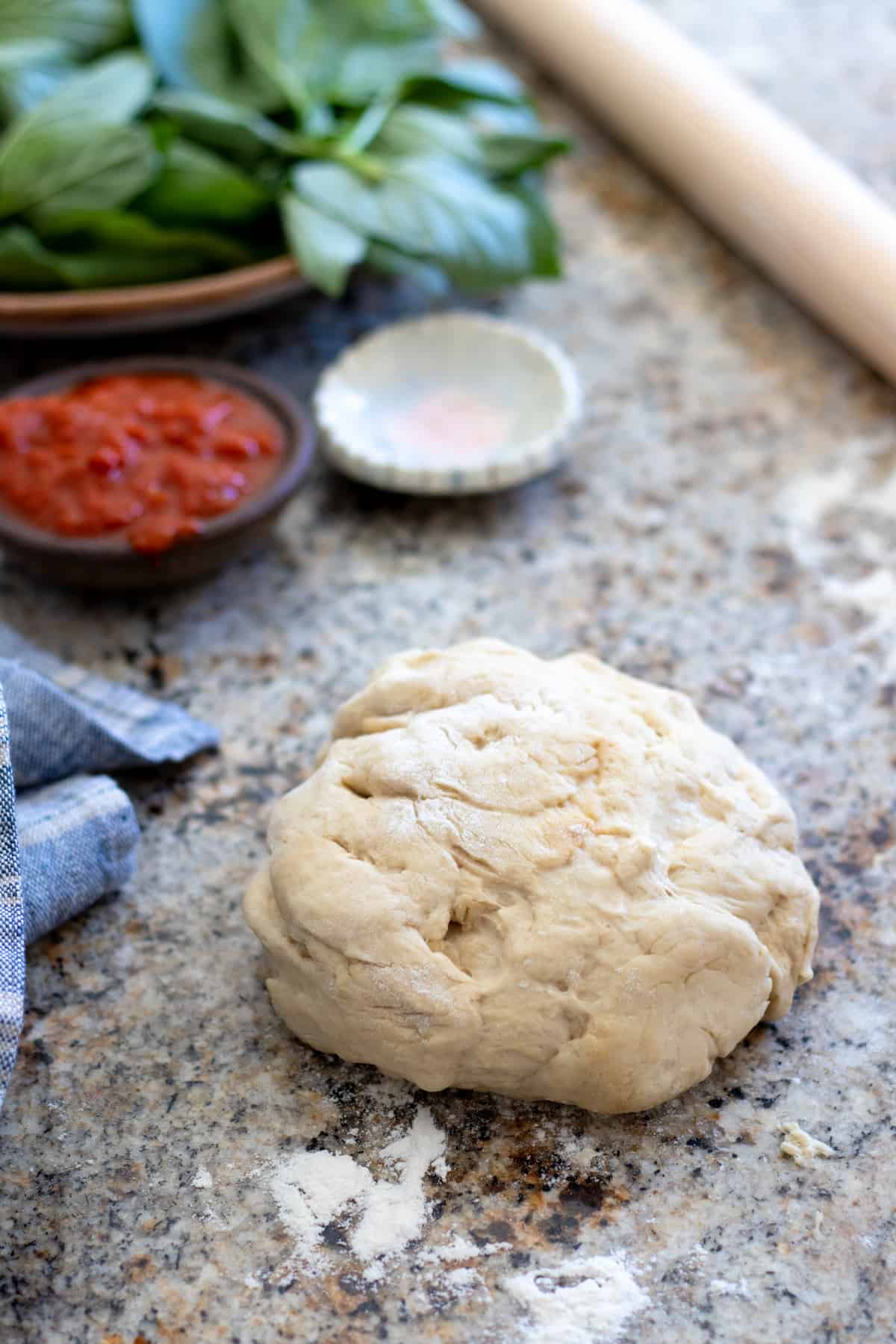 naan bread dough for flat bread pizza on floured surface