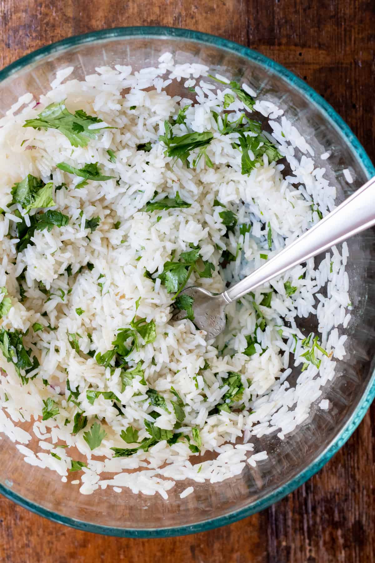 cilantro lime rice mixed with cilantro in glass bowl 