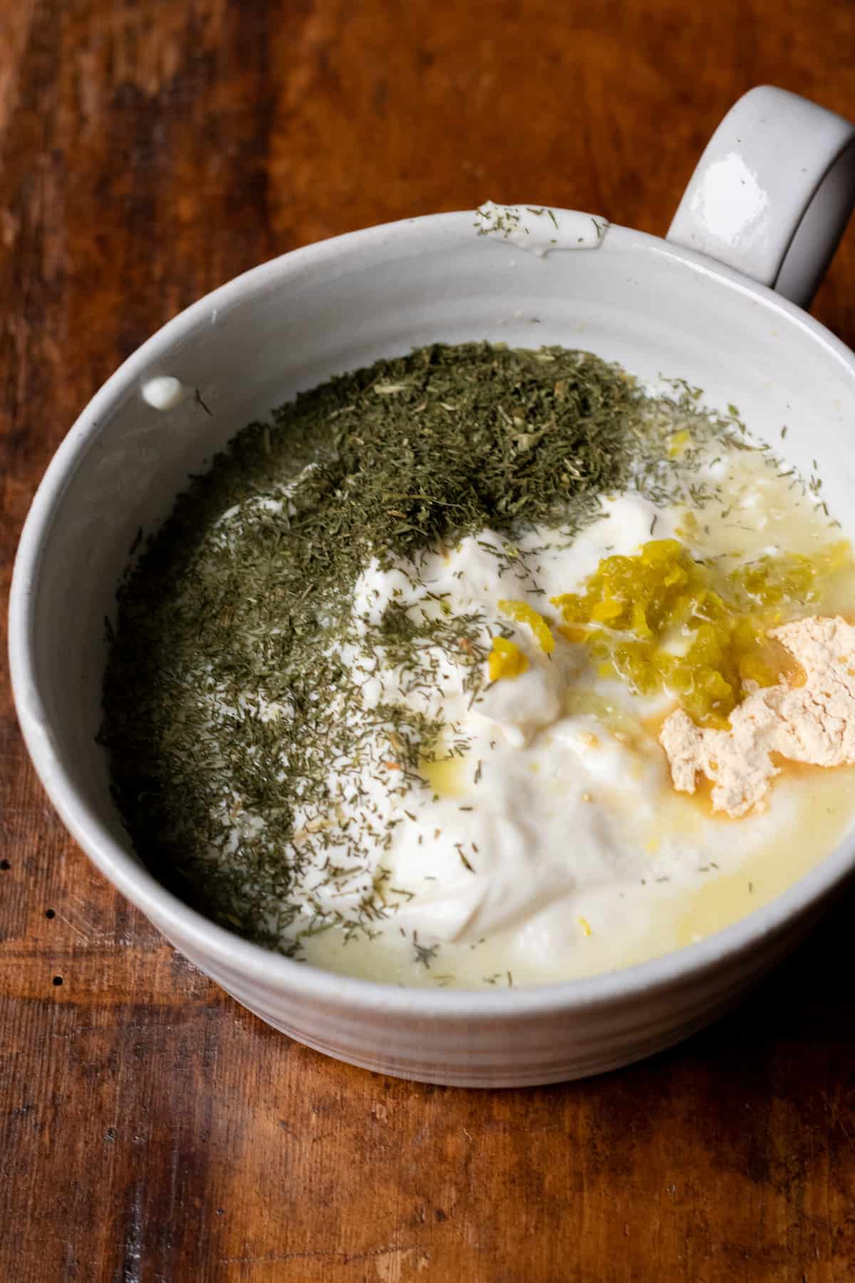 creamy dill sauce ingredients in white bowl