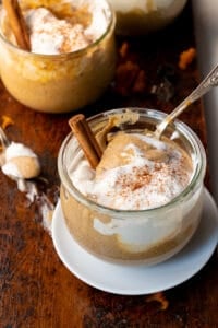 Pudding in glass jar with cinnamon stick