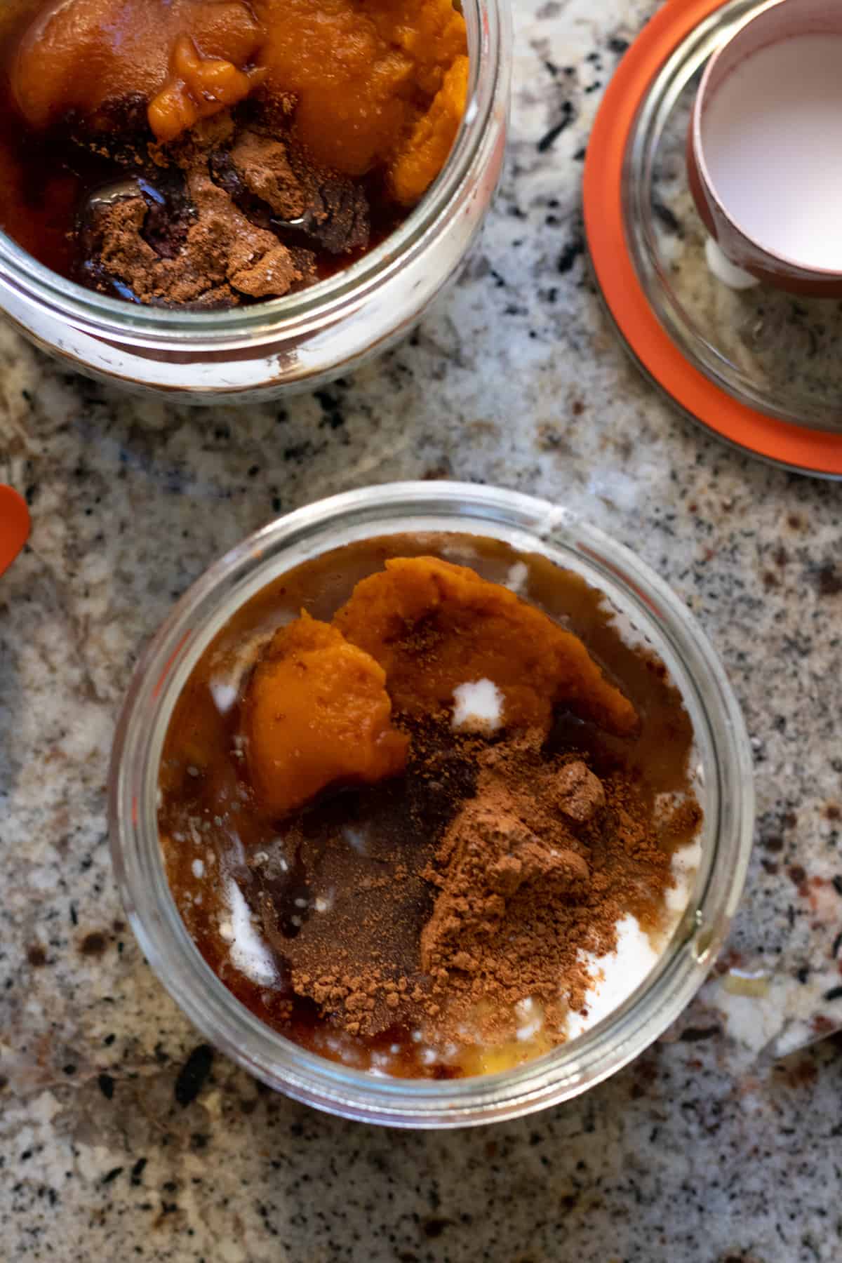 preparing pumpkin pudding ingredients in glass jar on kitchen counter