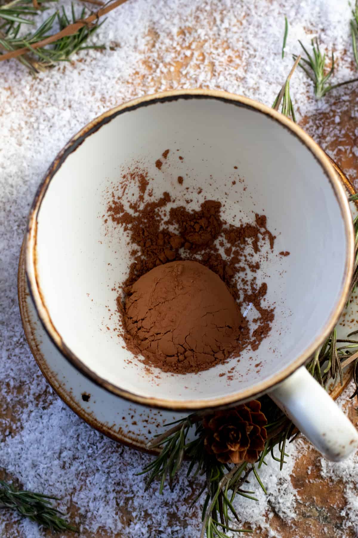 Cacao powder added to mug.