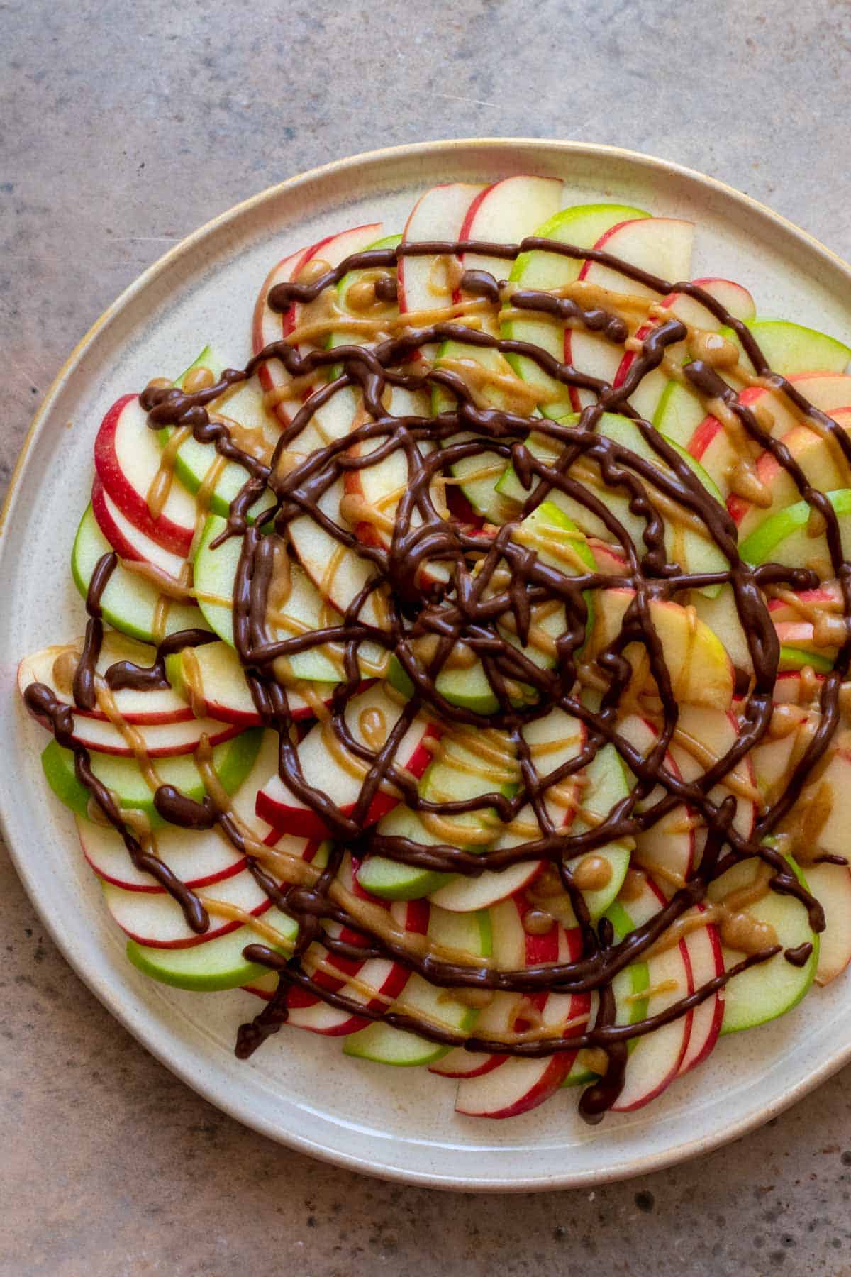 Apples drizzled with caramel and chocolate sauce.