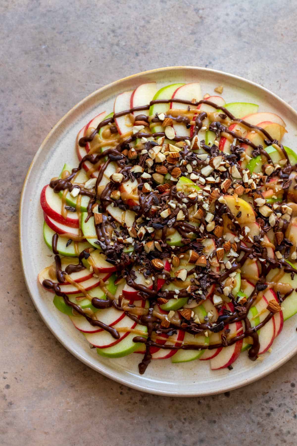 Nachos sprinkled with crushed nuts and cacao nibs.