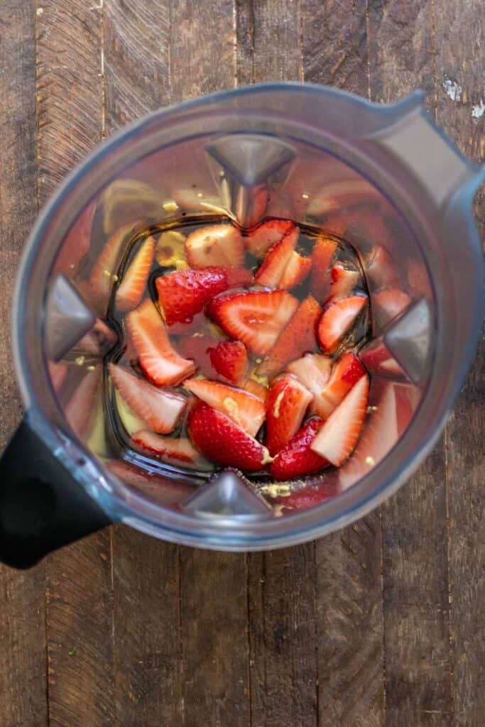 Strawberry dressing ingredients in blender canister before blending together.