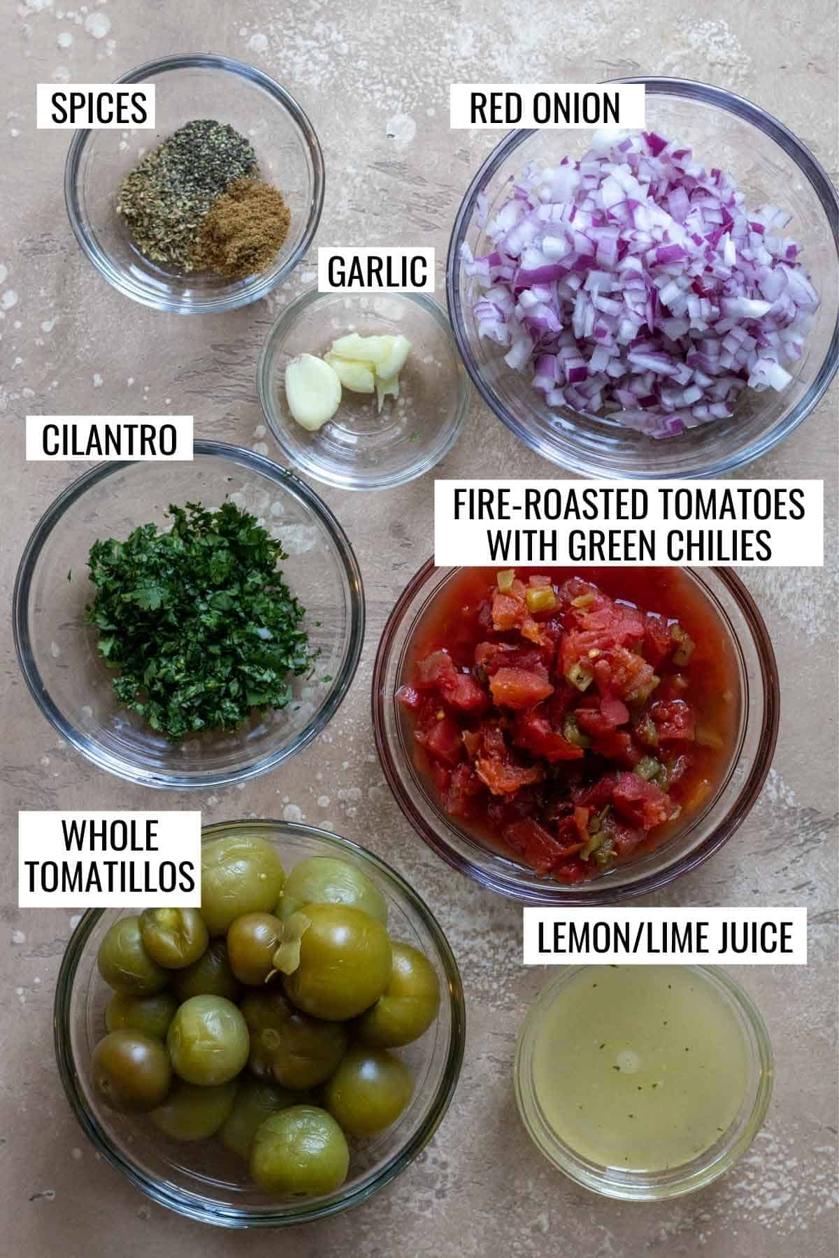 Ingredients for salsa measured and labeled in individual bowls.