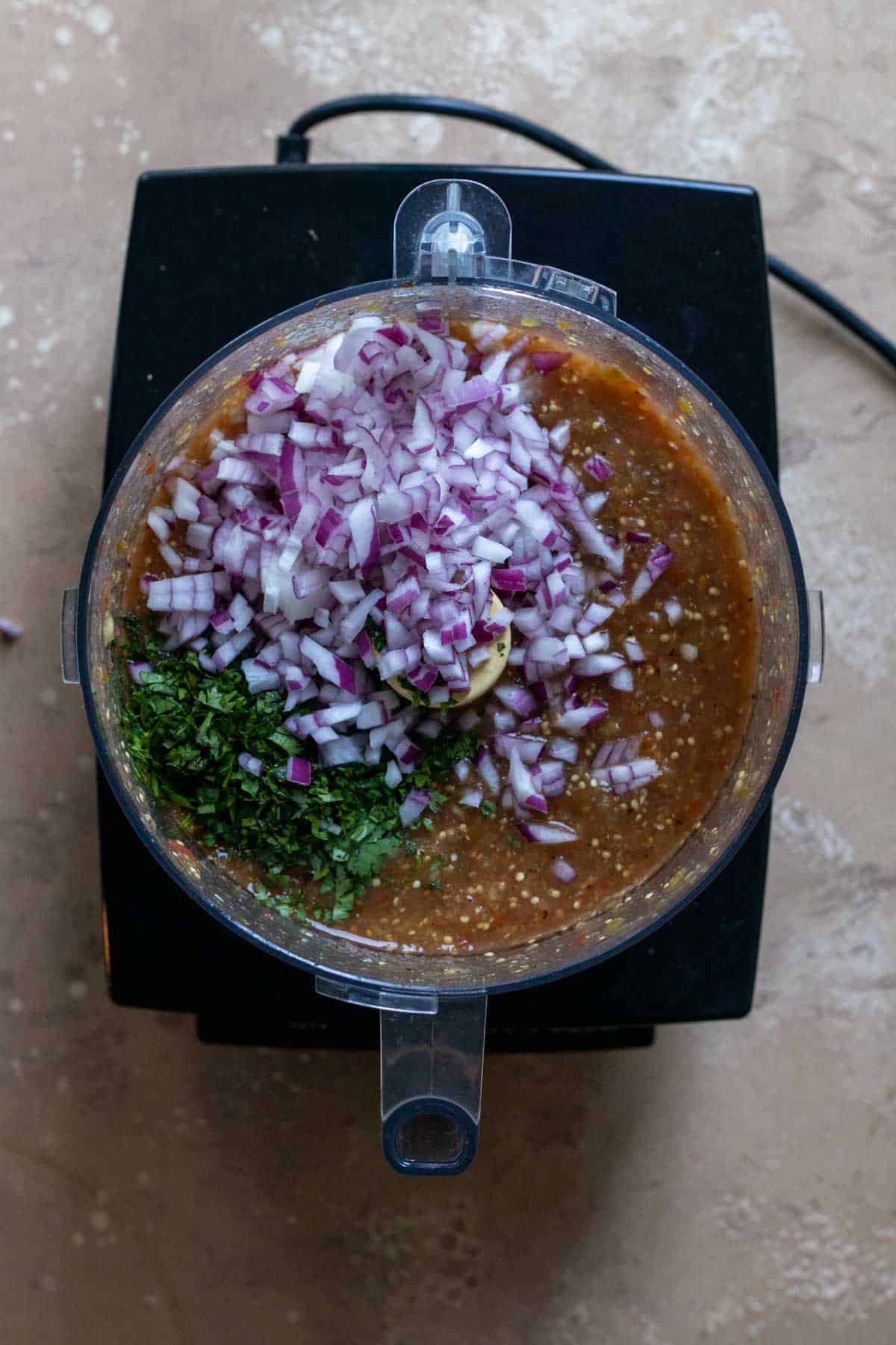 Diced Onion, cilantro and garlic added to food processor.
