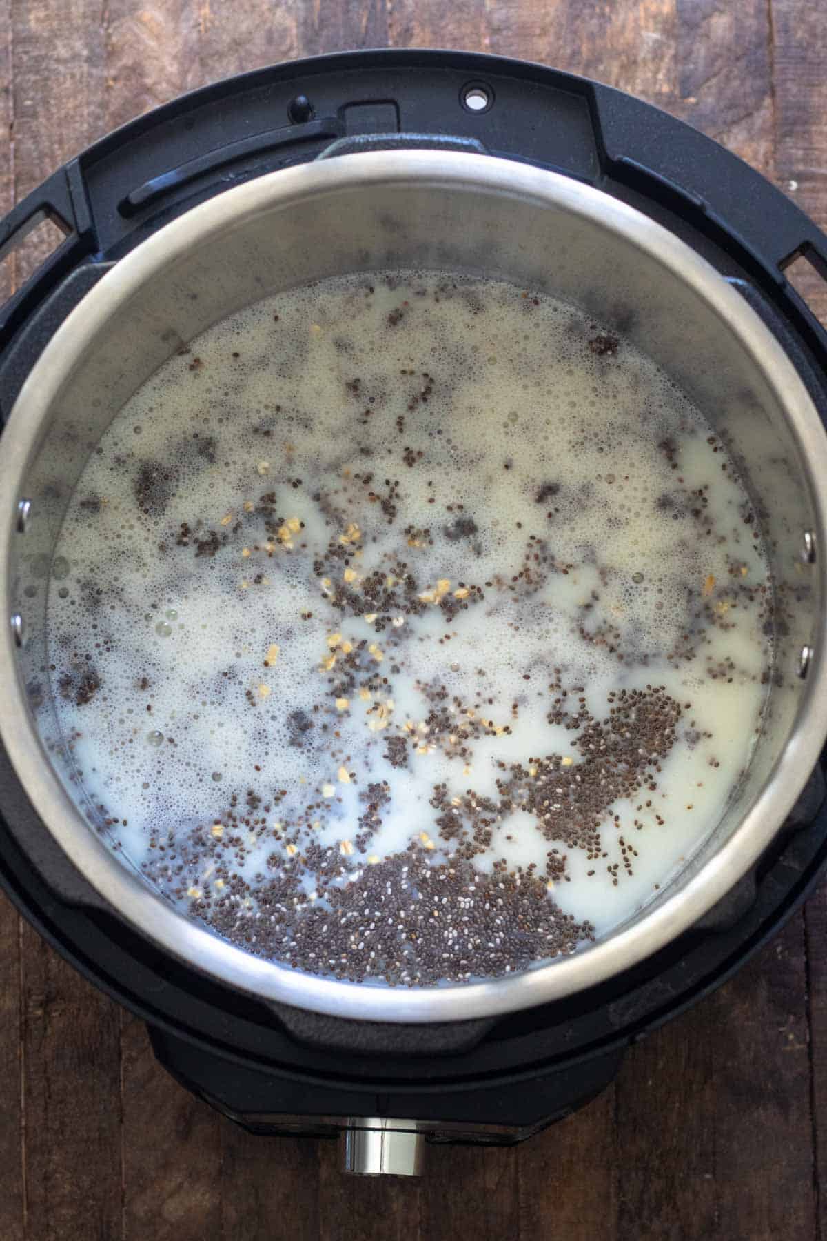 Oats added to milk mixture in Instant Pot.