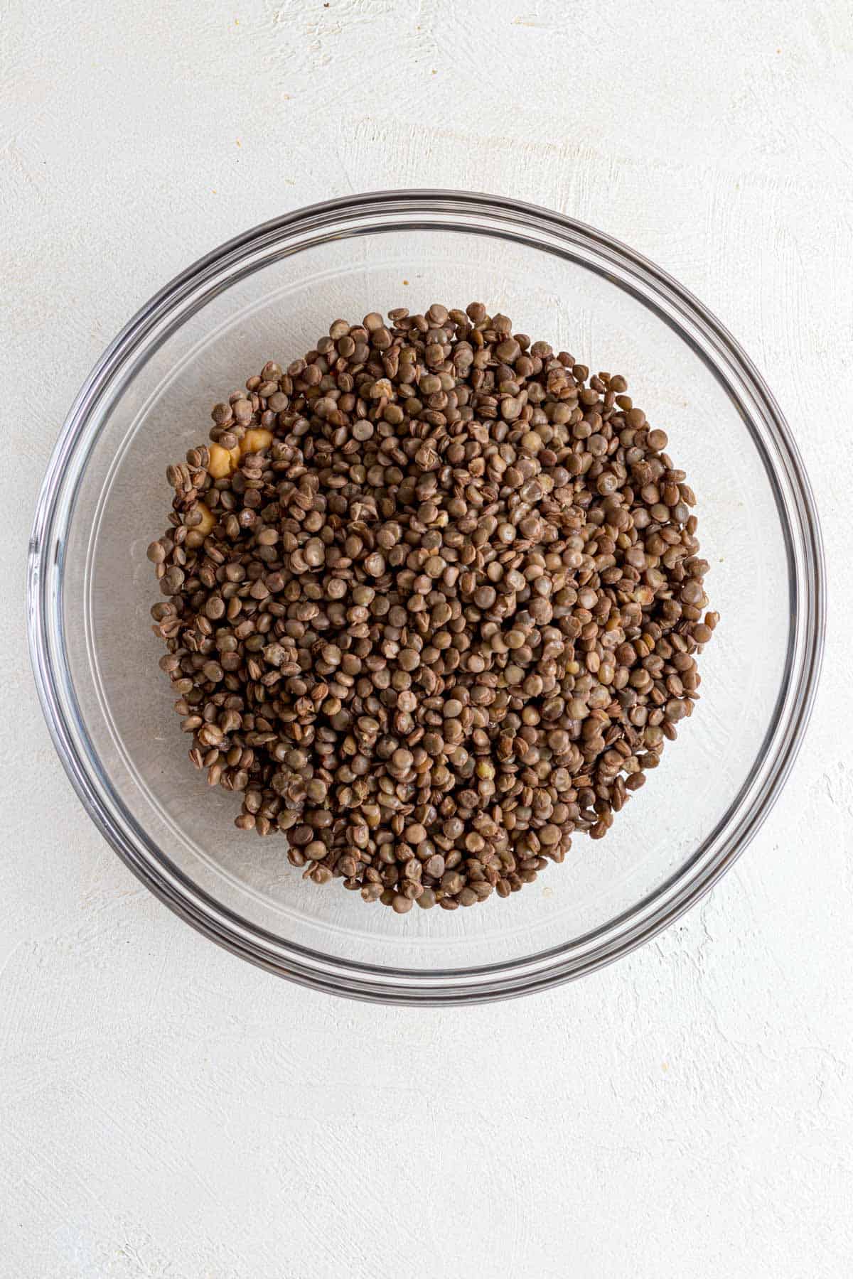 Lentils and chickpeas in glass mixing bowl.