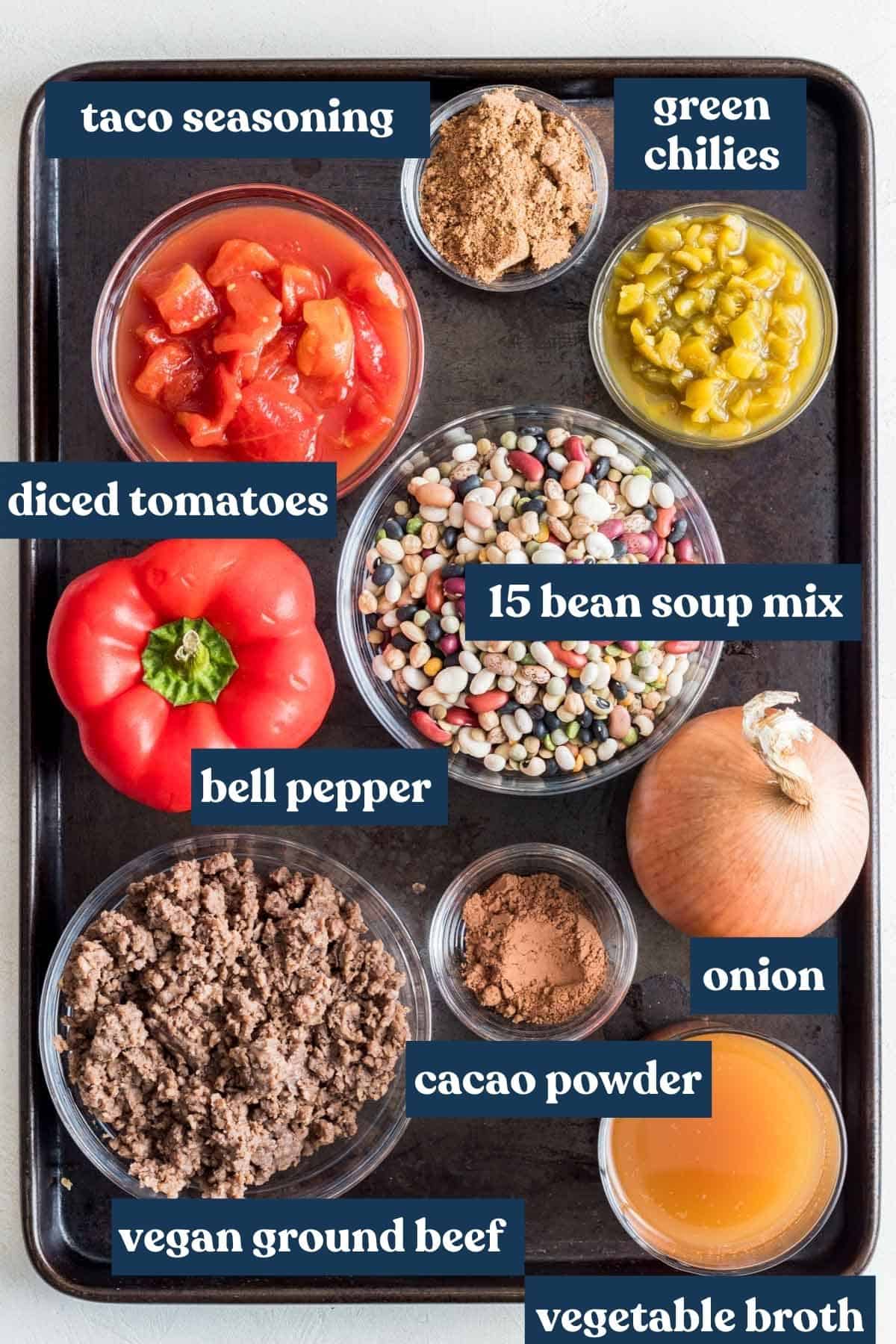 Ingredients needed for chili measured and labeled on baking sheet.