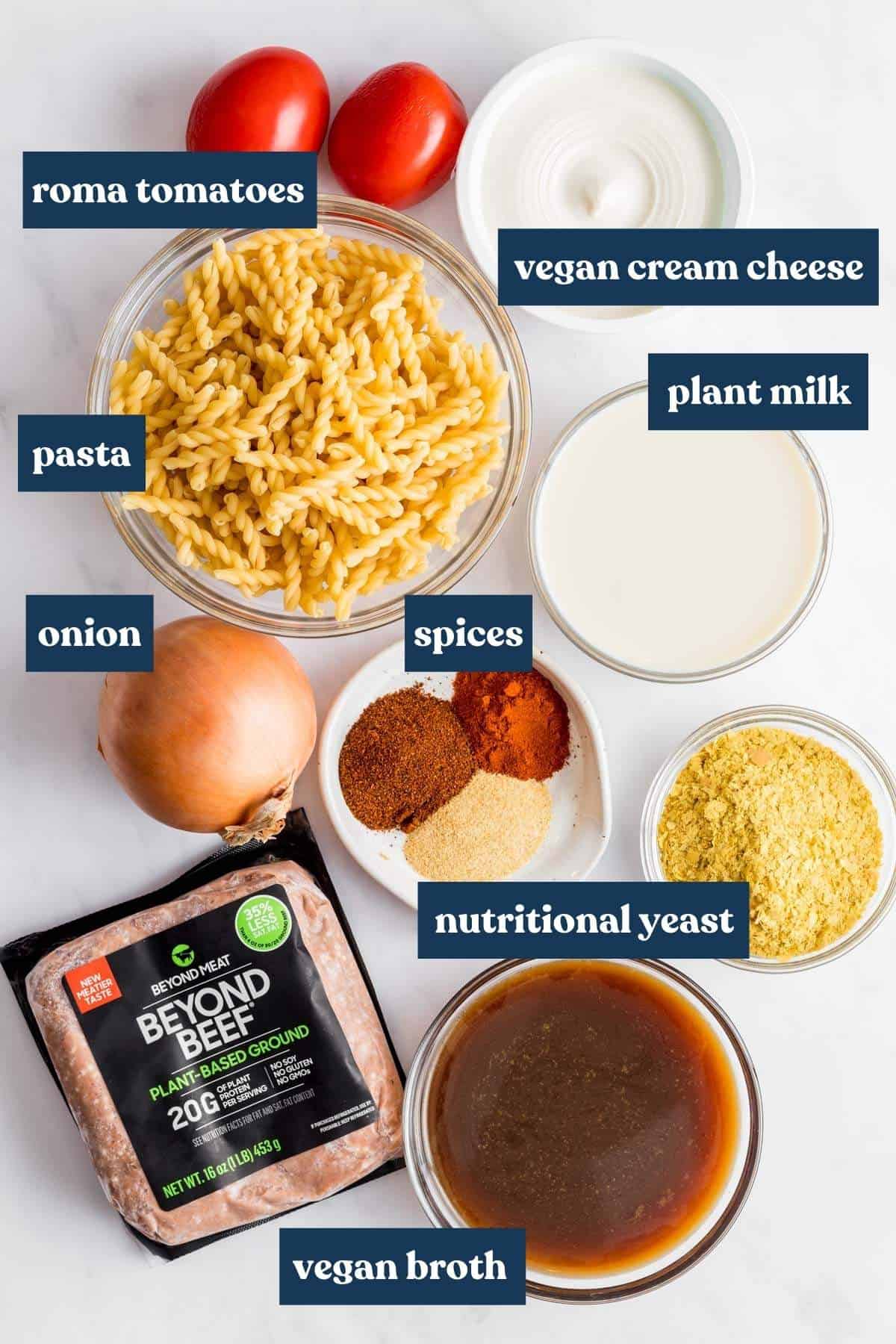 Vegan hamburger helper recipe ingredients on white backdrop. 