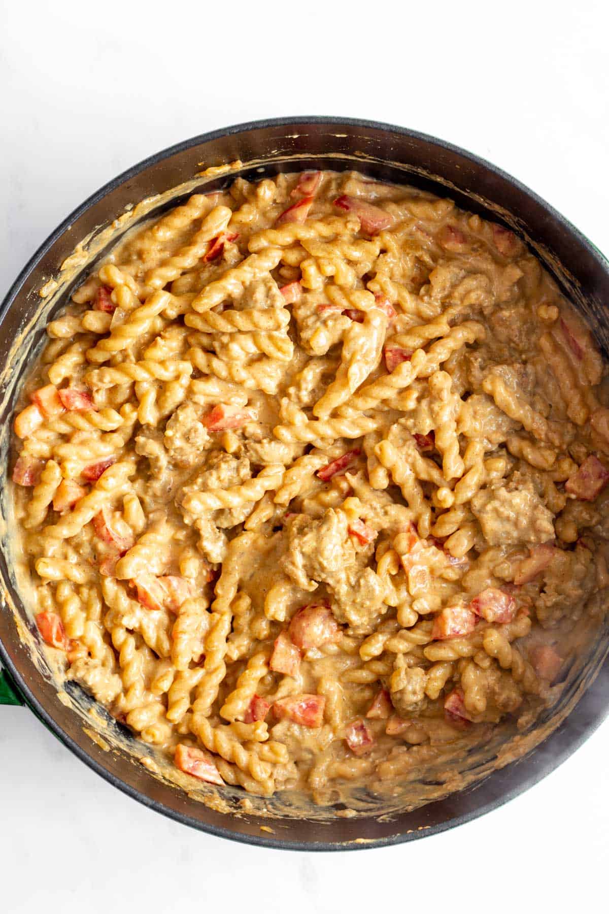 Hamburger helper pasta with tomatoes stirred in.