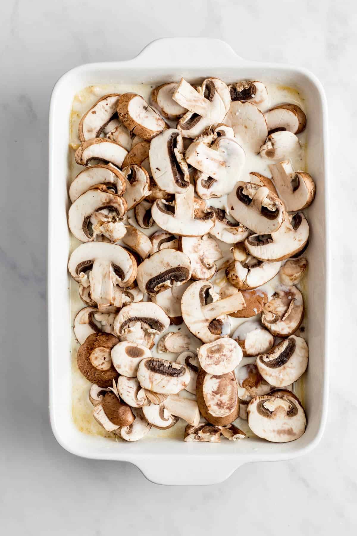 Mushrooms on top of pasta bake before baking.