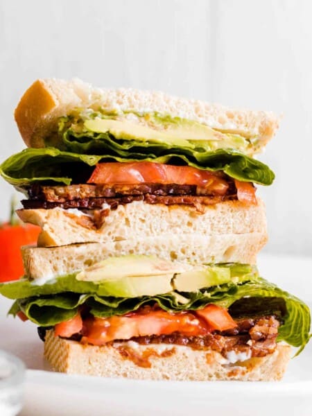 TTLA sandwich sliced into two halves and stacked on top of one another.