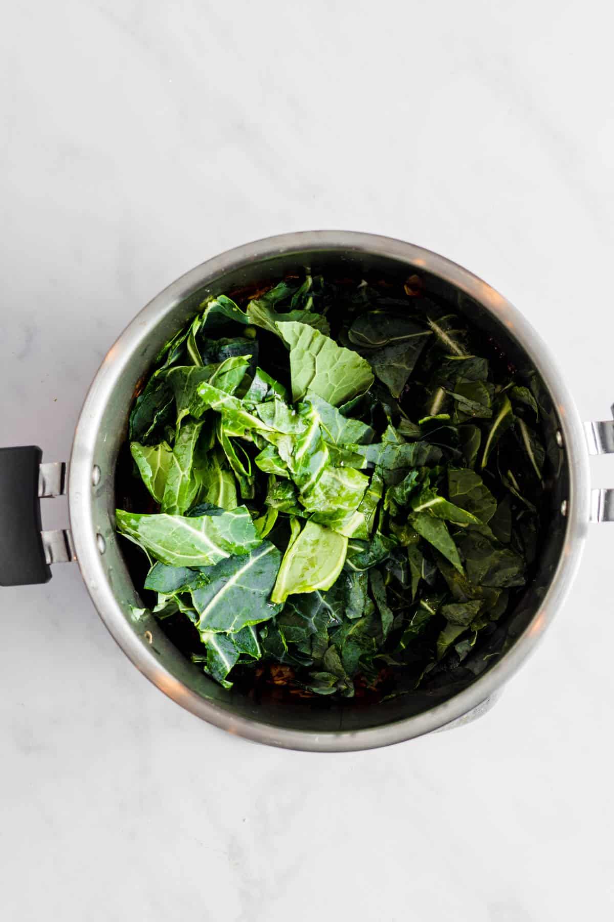 Chopped collard greens added to the Instant Pot.