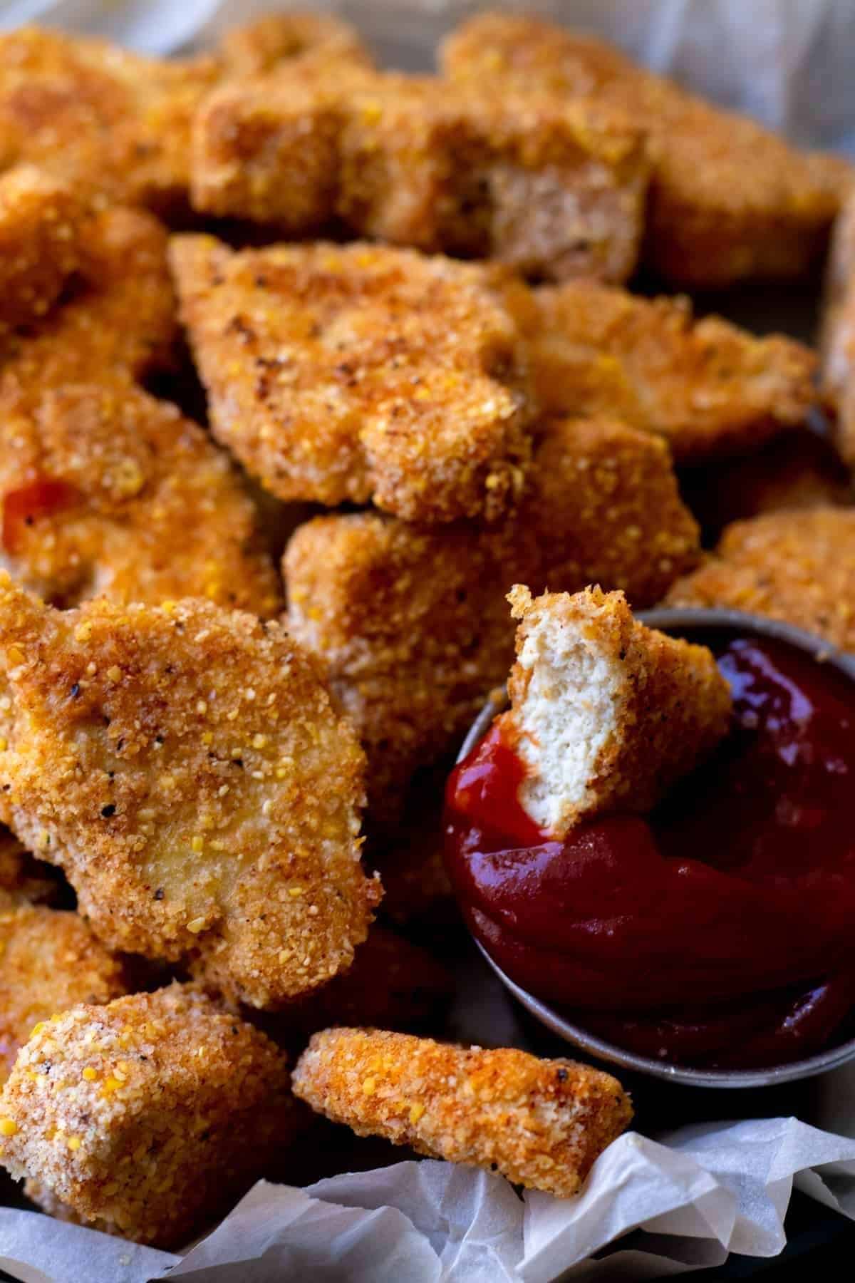 Tofu nuggets dunked in ketchup.