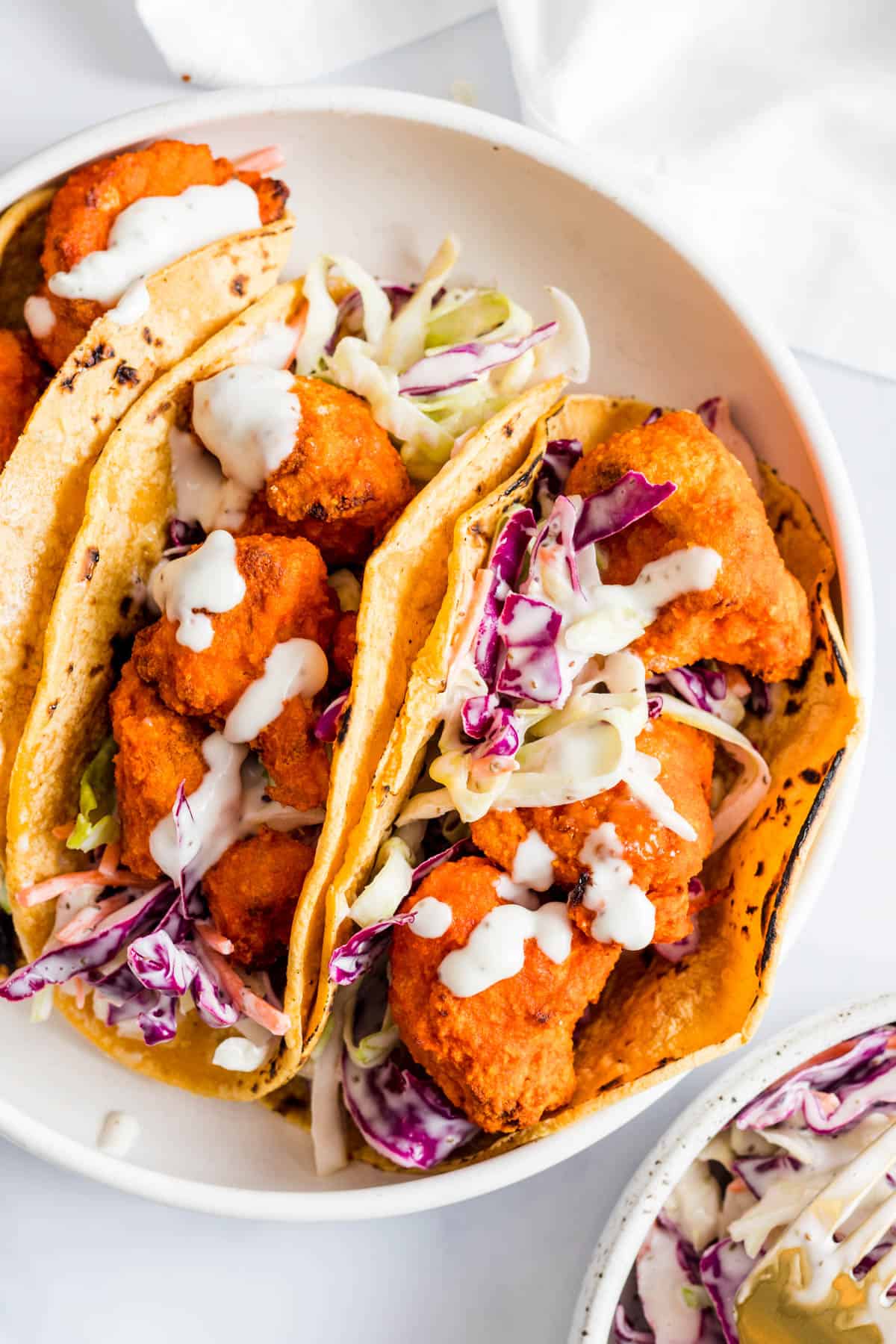 Breaded cauliflower tacos with coleslaw.