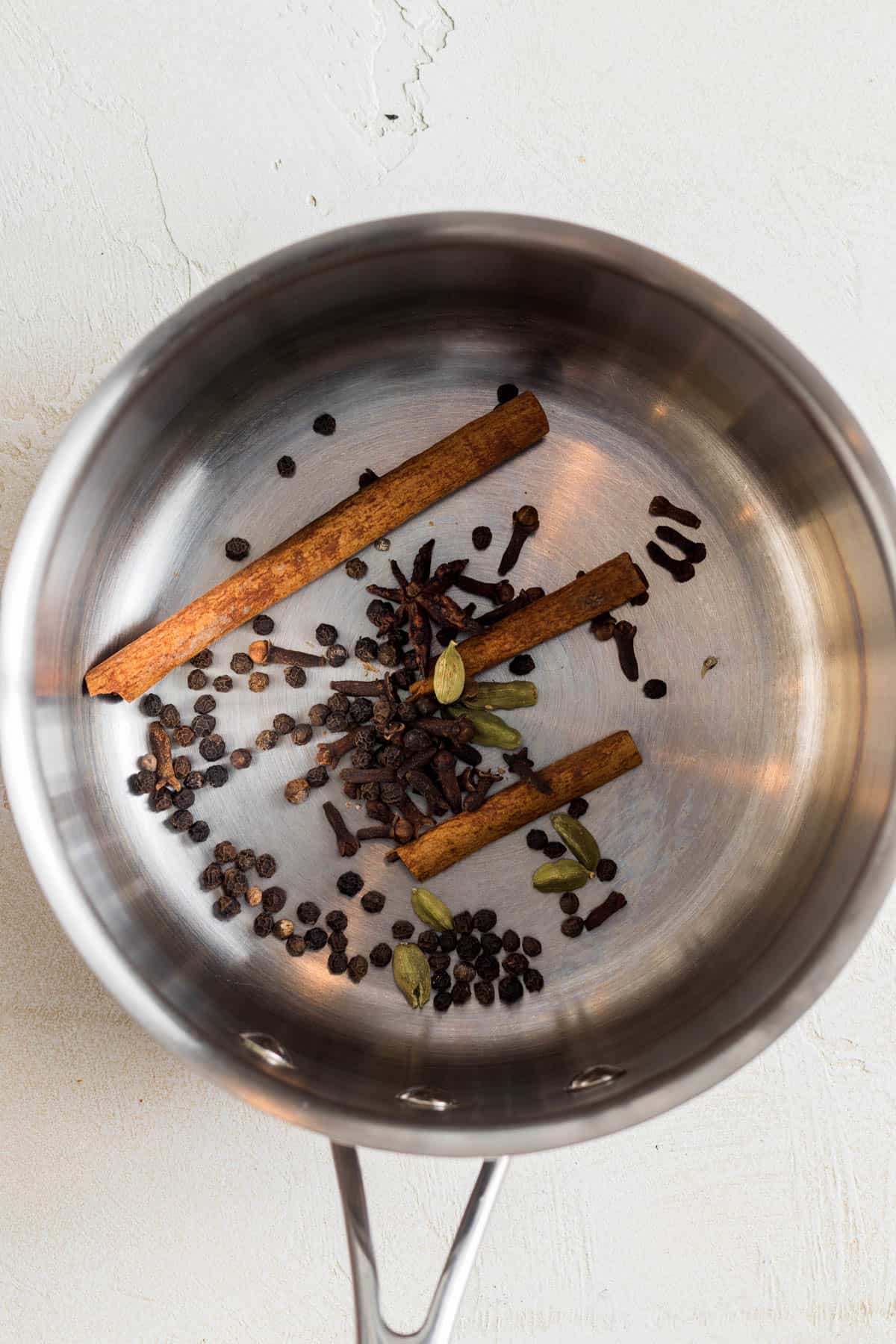 Spices toasting in a sauce pan.