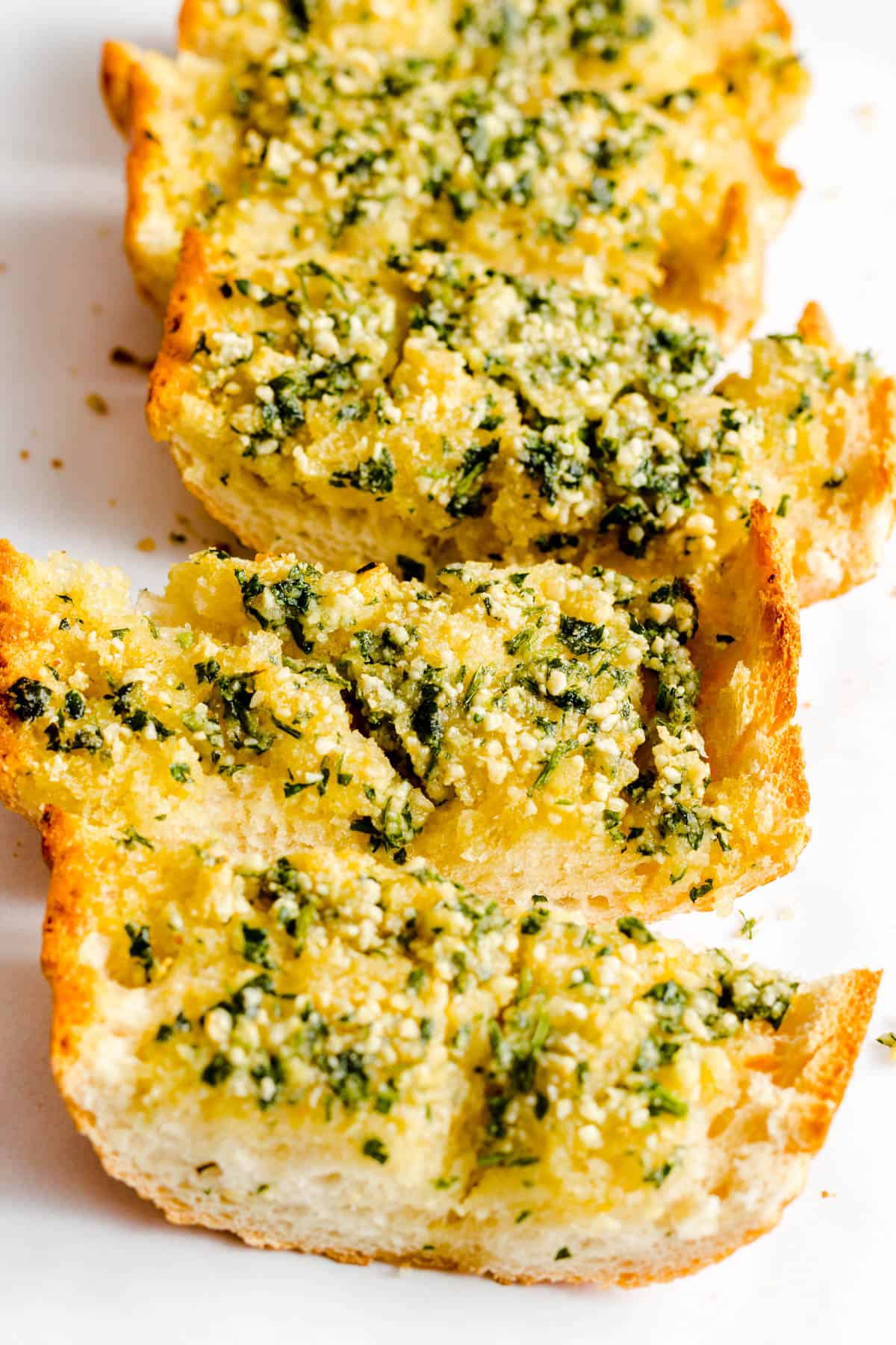 Crusty garlic bread slices with parsley.