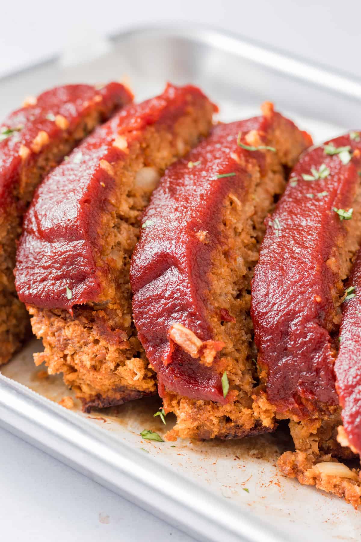 Closeup of meatloaf on baking tray.