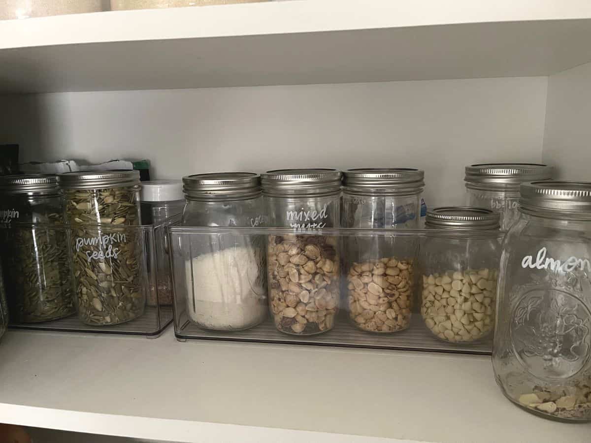 Nuts and seeds stored in glass jars.