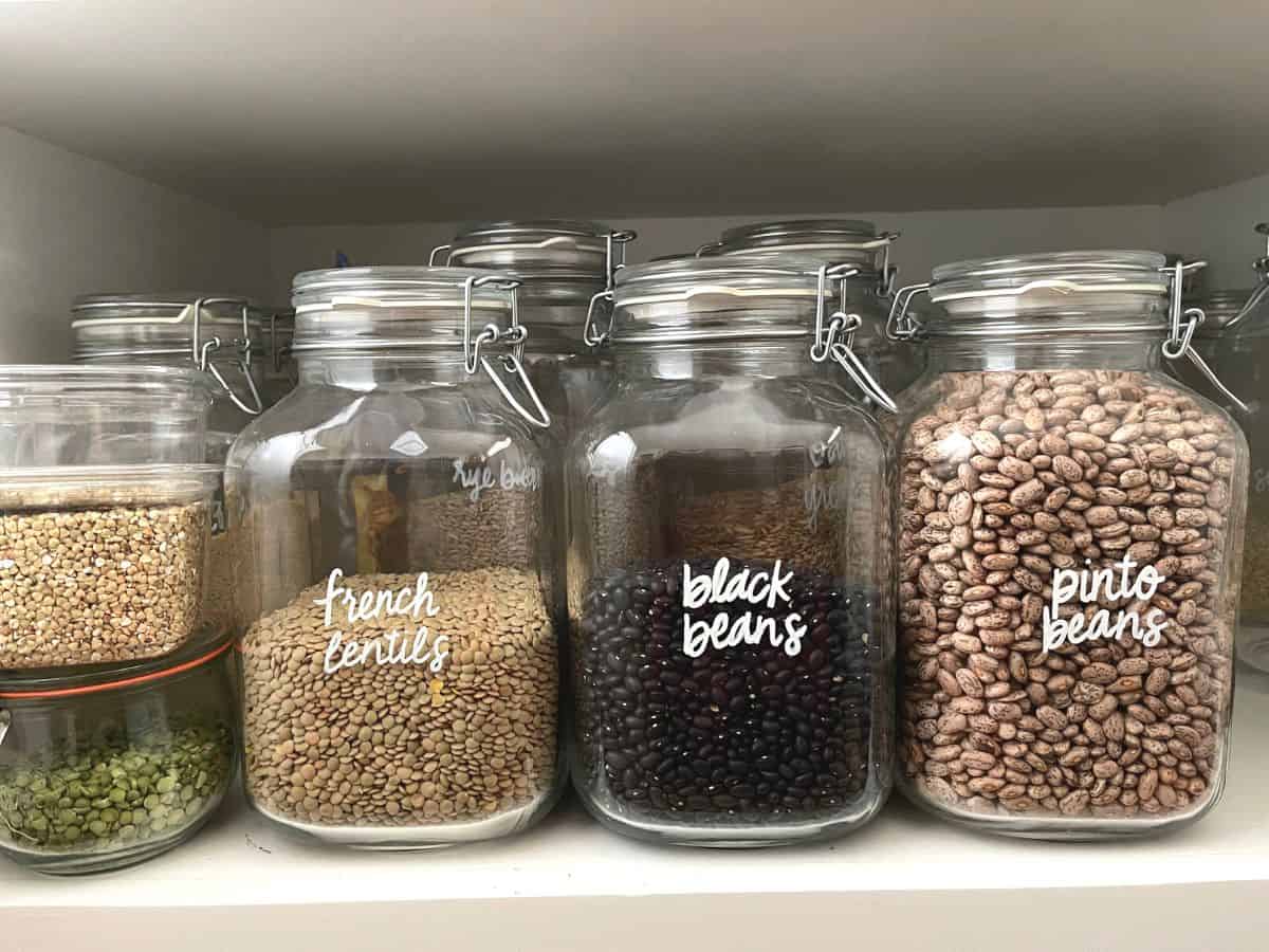 Legumes stored in large glass jars.
