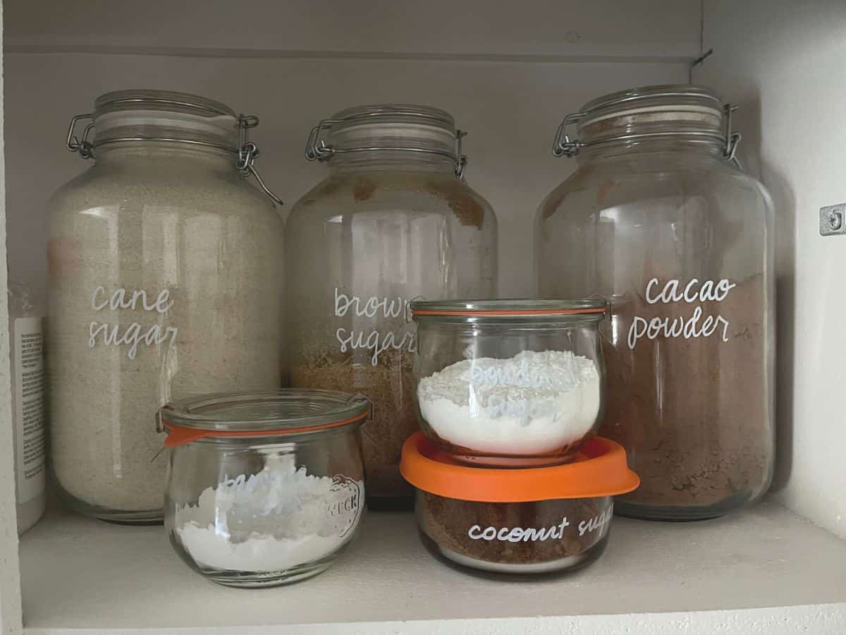 Glass jars filled with sugars and baking items.