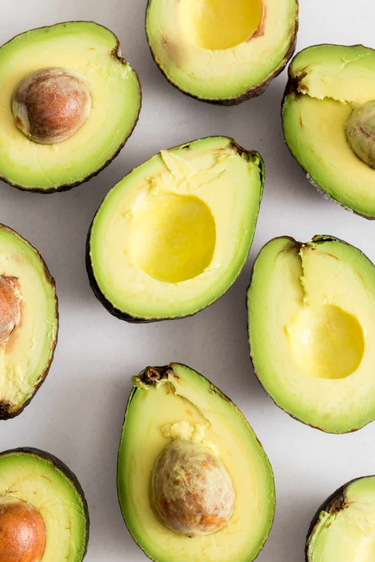 Close up of avocados cut in half.