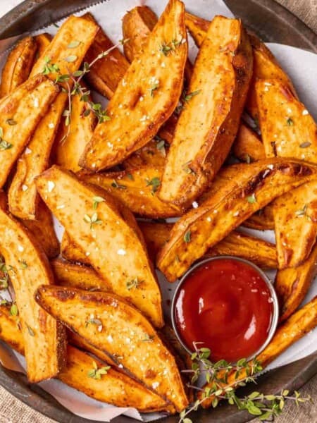 Sweet potato wedges garnished with herbs.