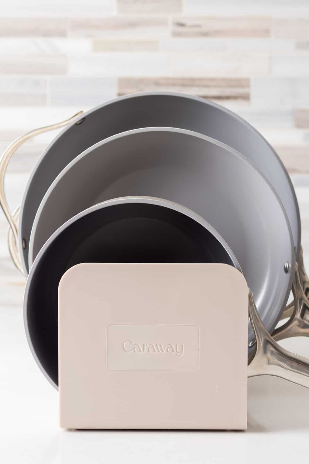 Caraway logo on cookware stand.