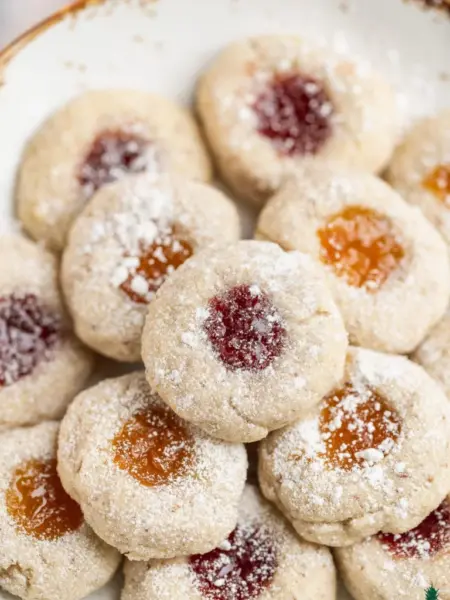 Thumbprint cookies filled with jam and dusted with sugar.