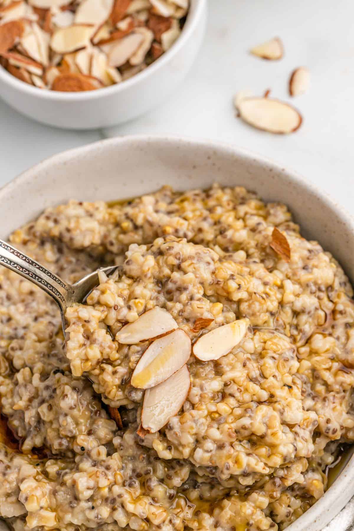 Bowl of oatmeal with slivered almonds.