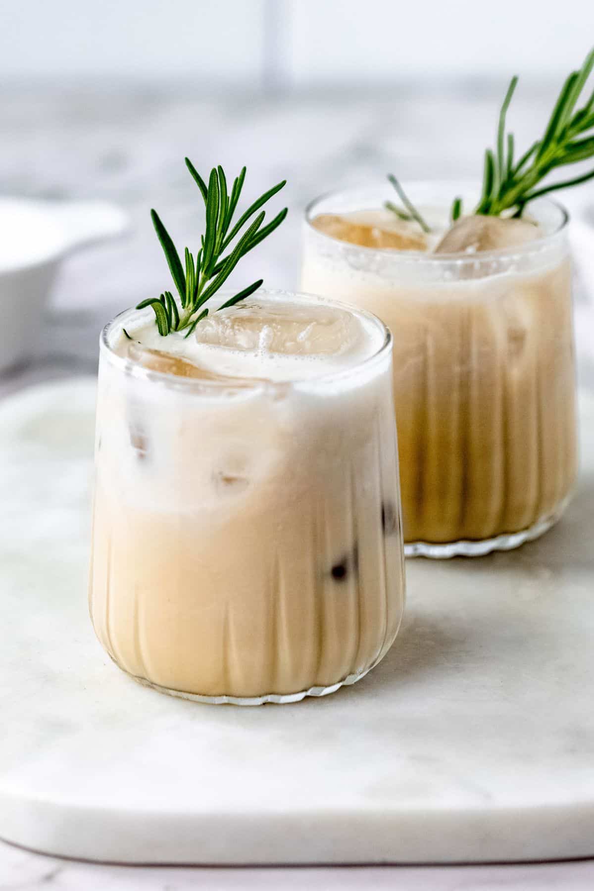 Cocktails garnished with fresh rosemary.
