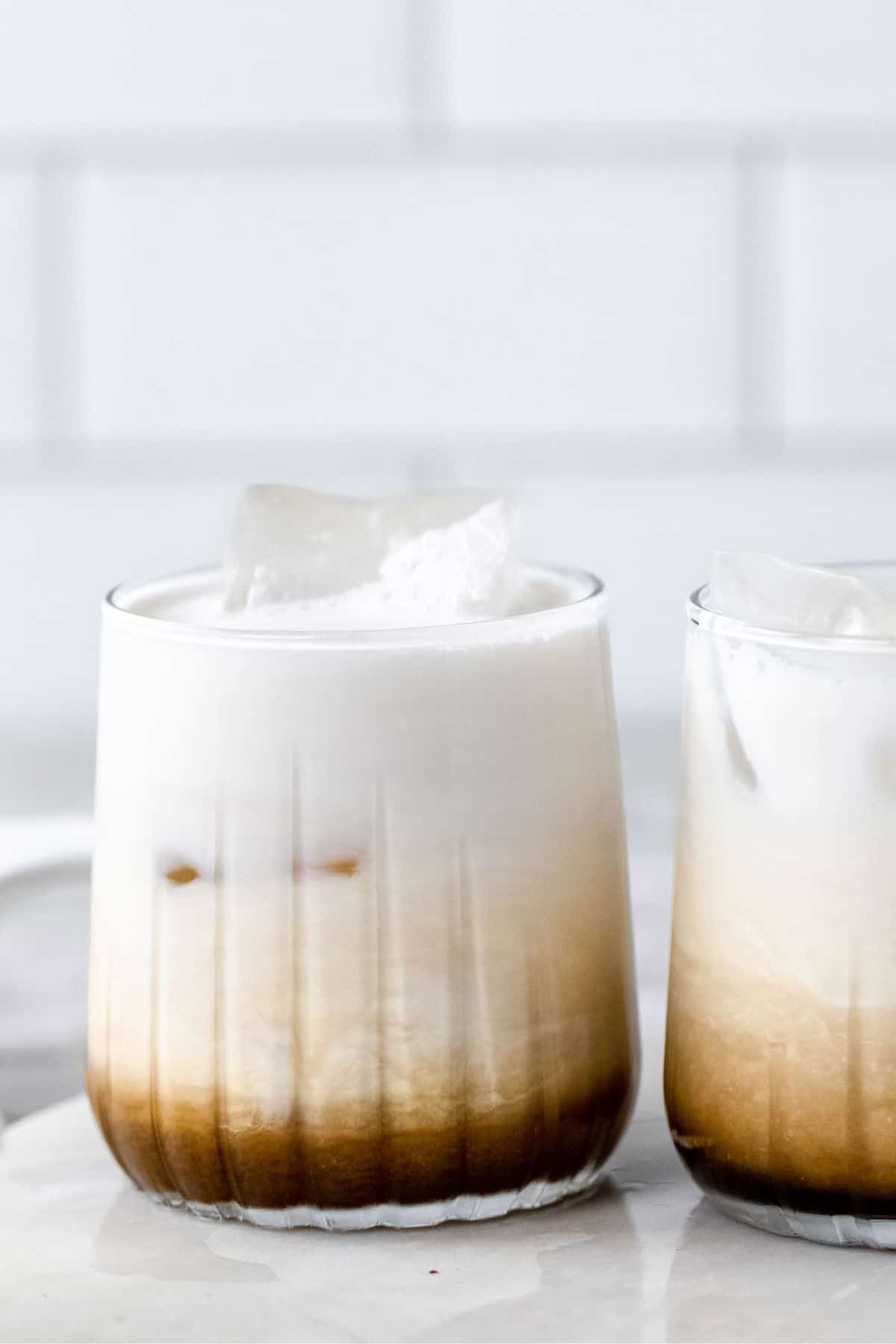 Two white russians in cocktail glasses.