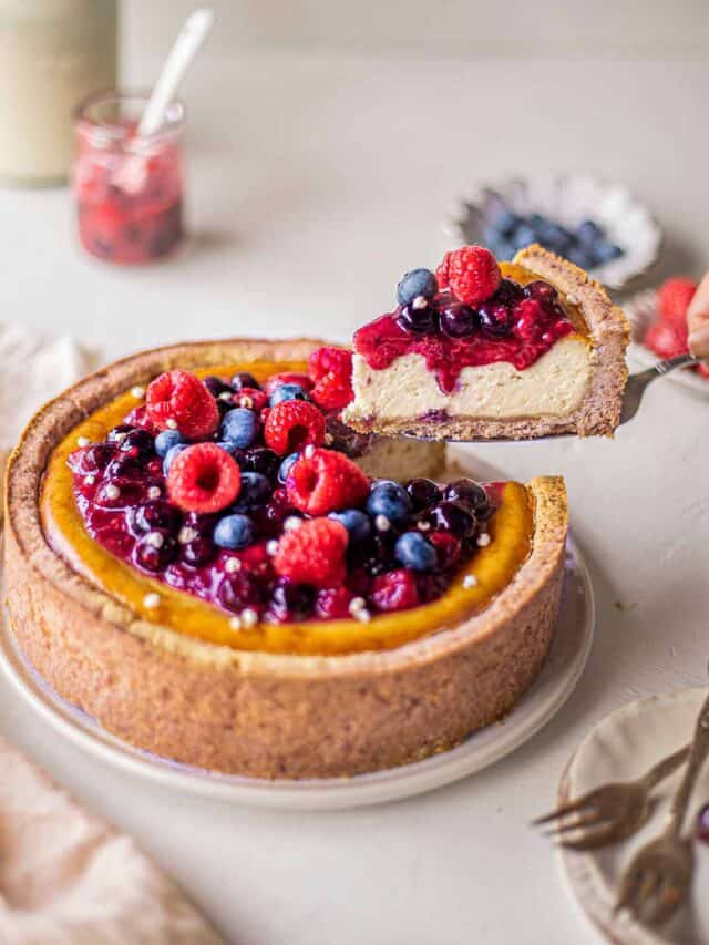 A slice of baked cheesecake topped with fresh fruit.