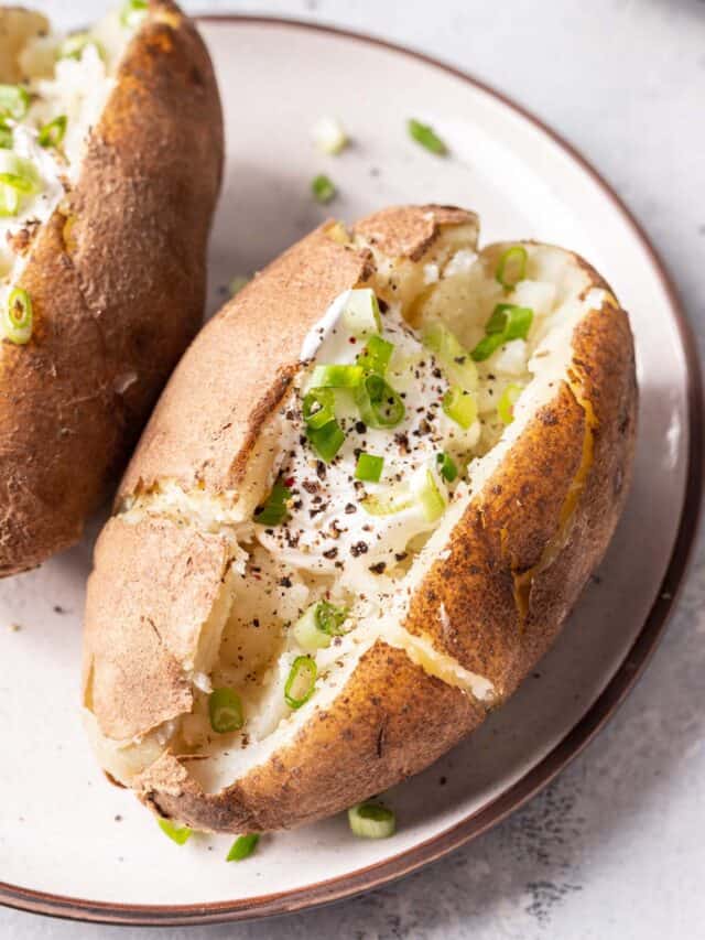 Closeup of baked potato on plate.