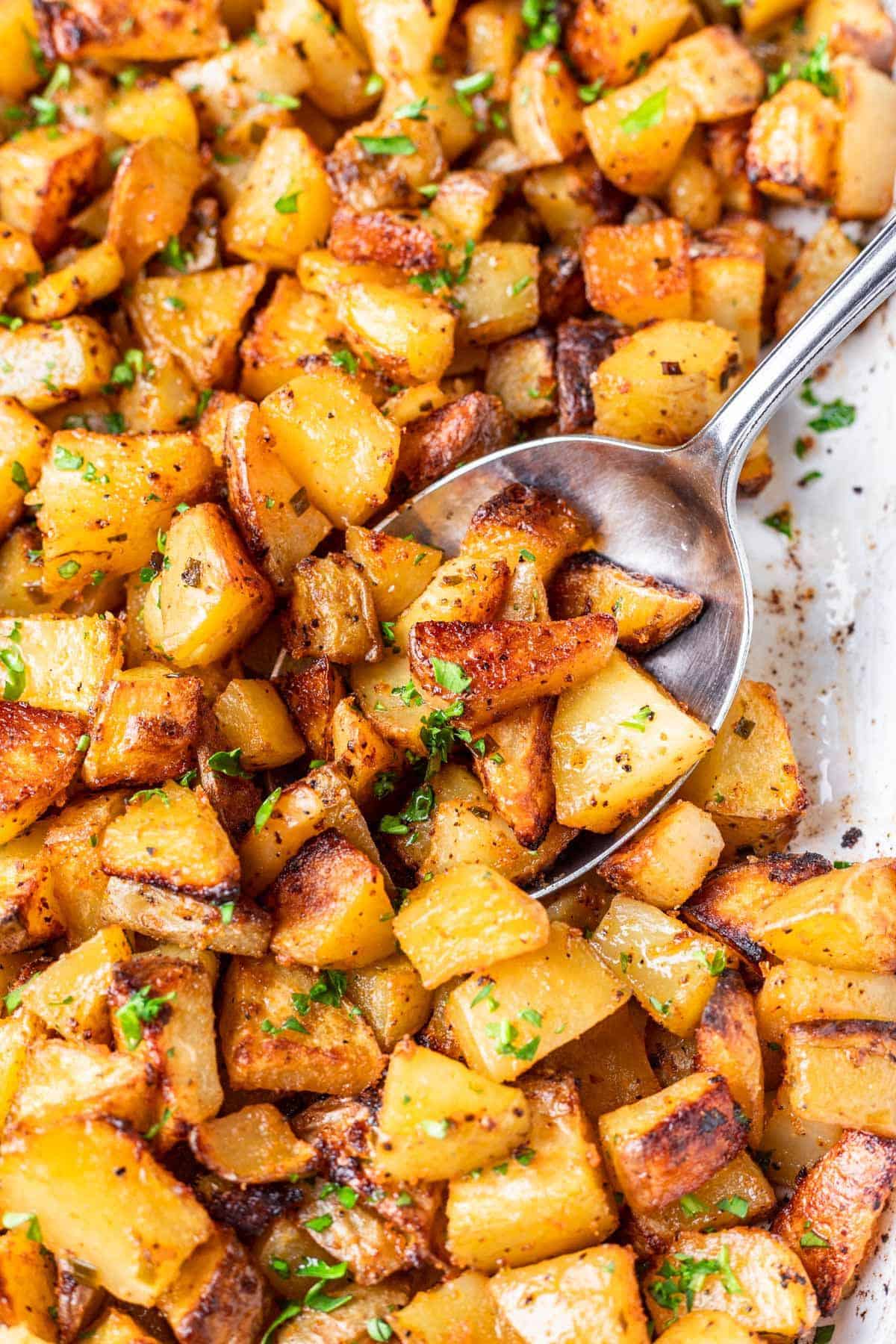 Roasted potatoes on a spoon.