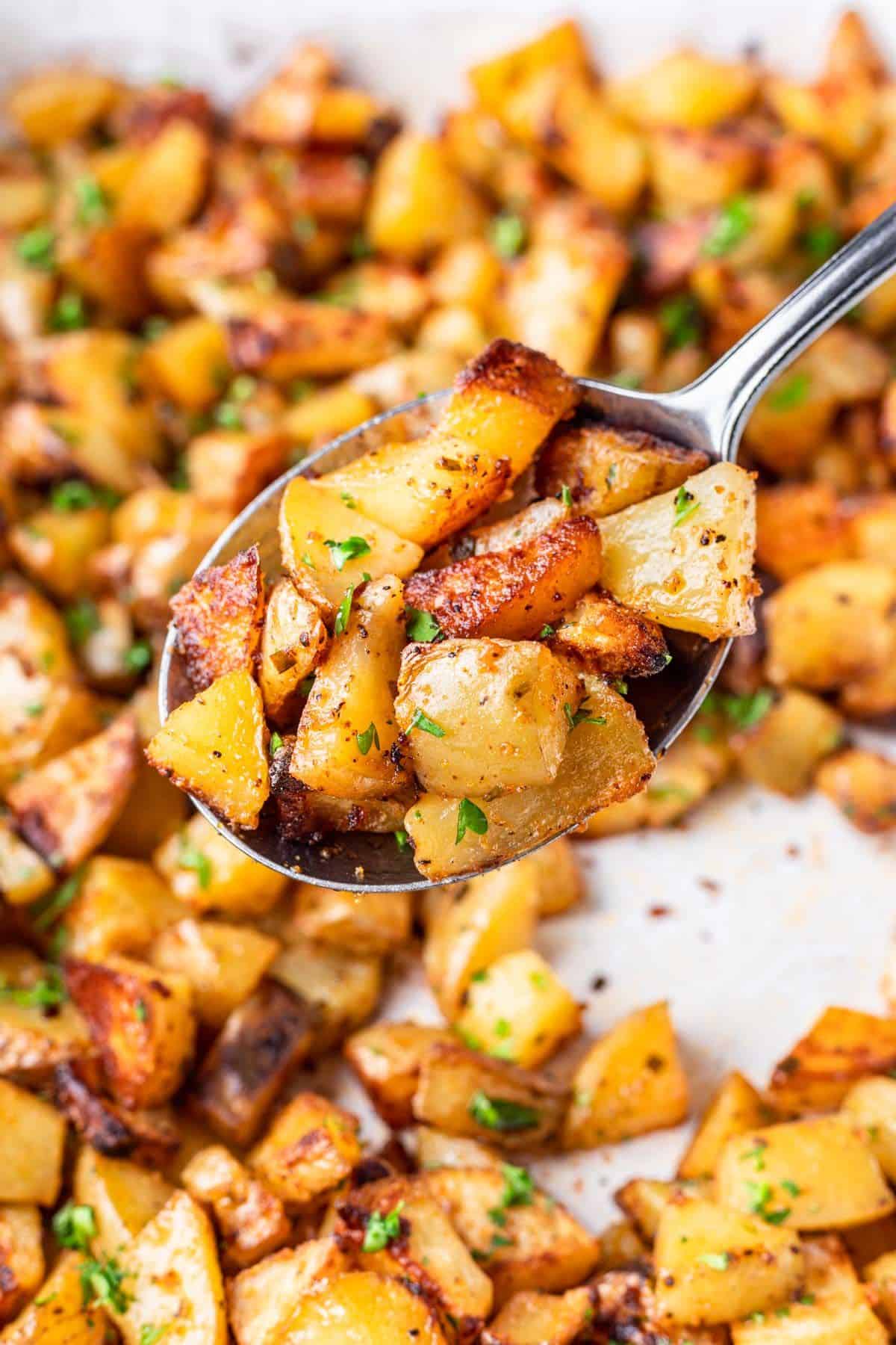 Spoonful of oven roasted potatoes.