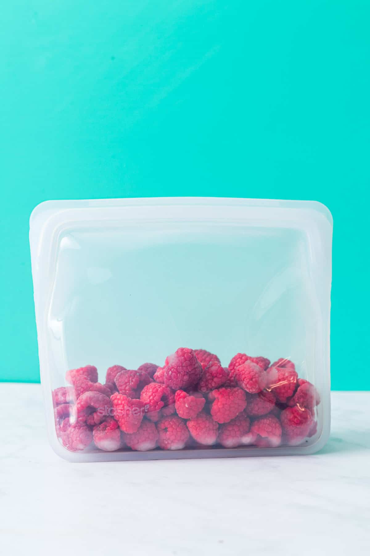 Open bag of frozen raspberries.
