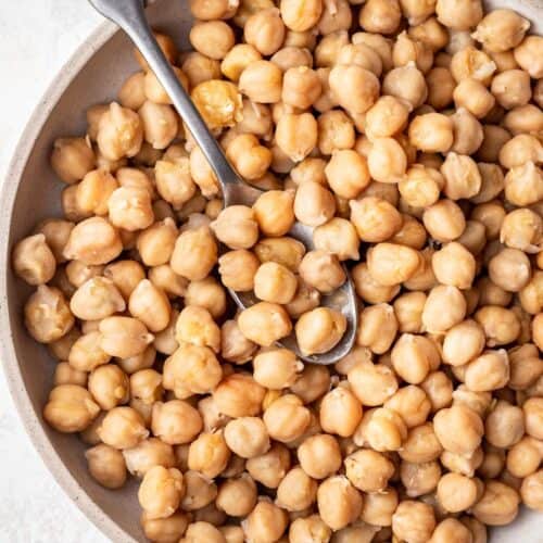 Bowl of cooked chickpeas with spoon.