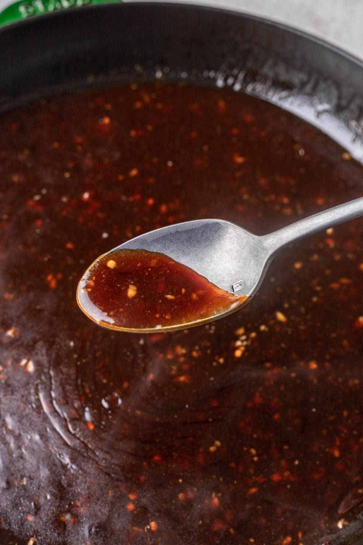 Spoonful of general tso's sauce after thickening.