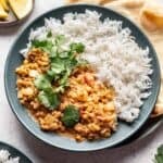 Lentil curry served with white rice, fresh lemon and cilantro.