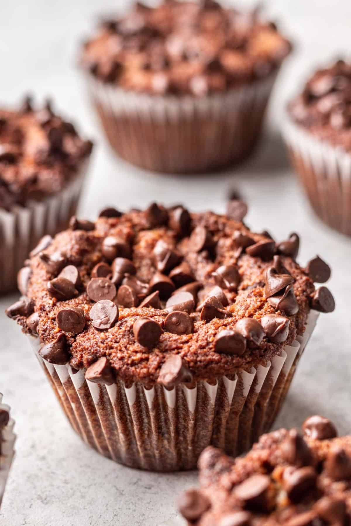 Muffins topped with chocolate chips.
