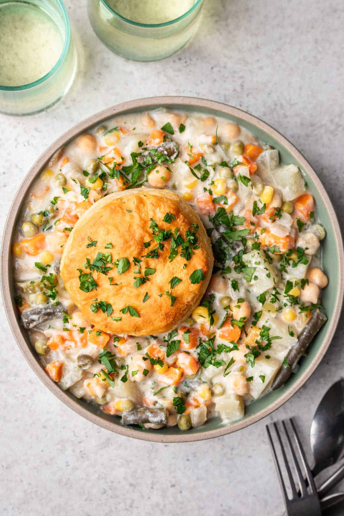 Bowl of vegan pot pie filling with biscuits.