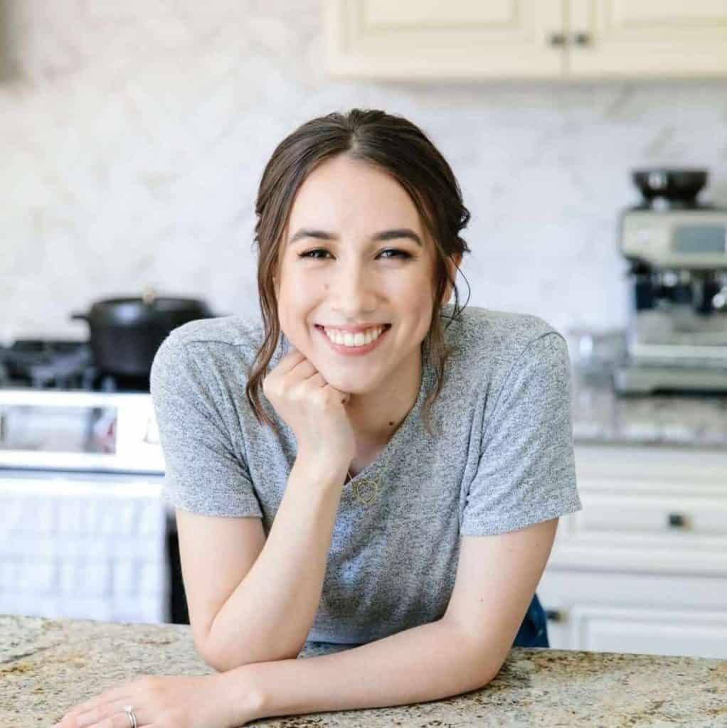 Nicolette, author of Home-Cooked roots, smiling in kitchen.
