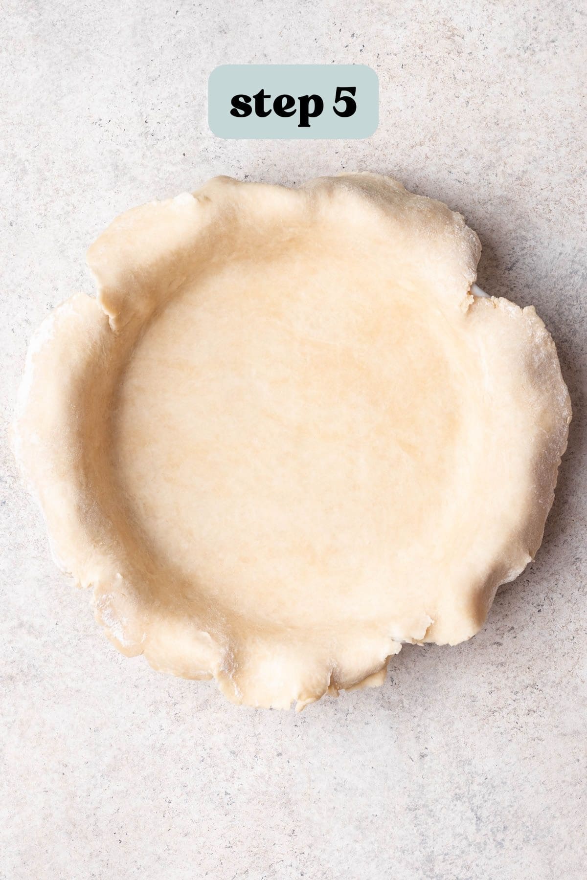 Pie crust in pie dish before trimming edges.
