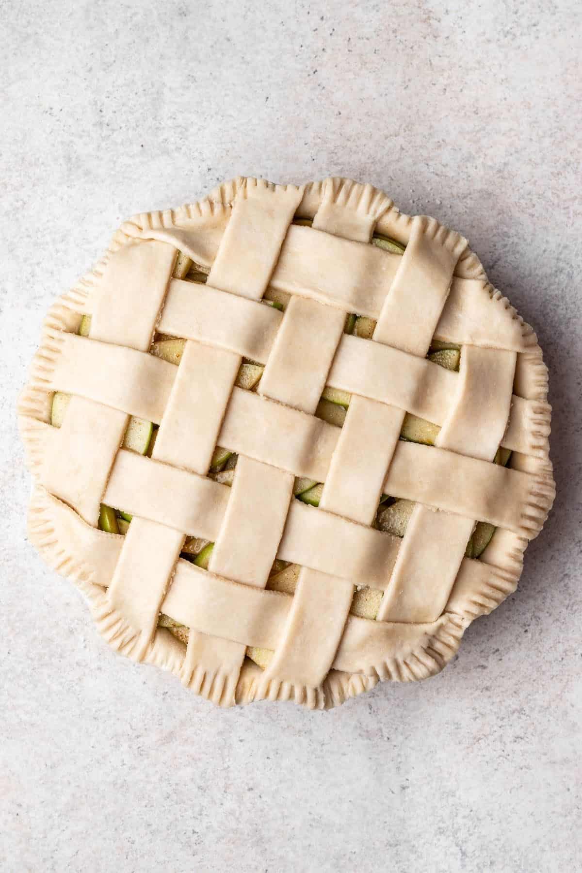 Pie crust lattice top overtop a homemade apple pie.