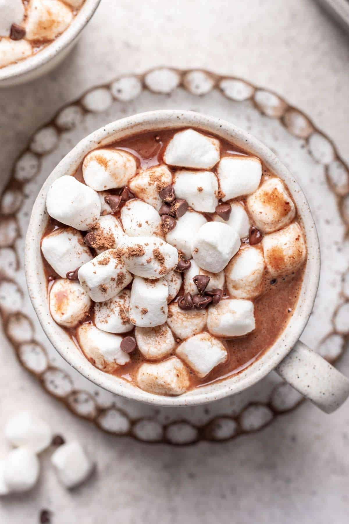 Closeup of mug of hot chocolate with marshmallows and mini chocolate chips.