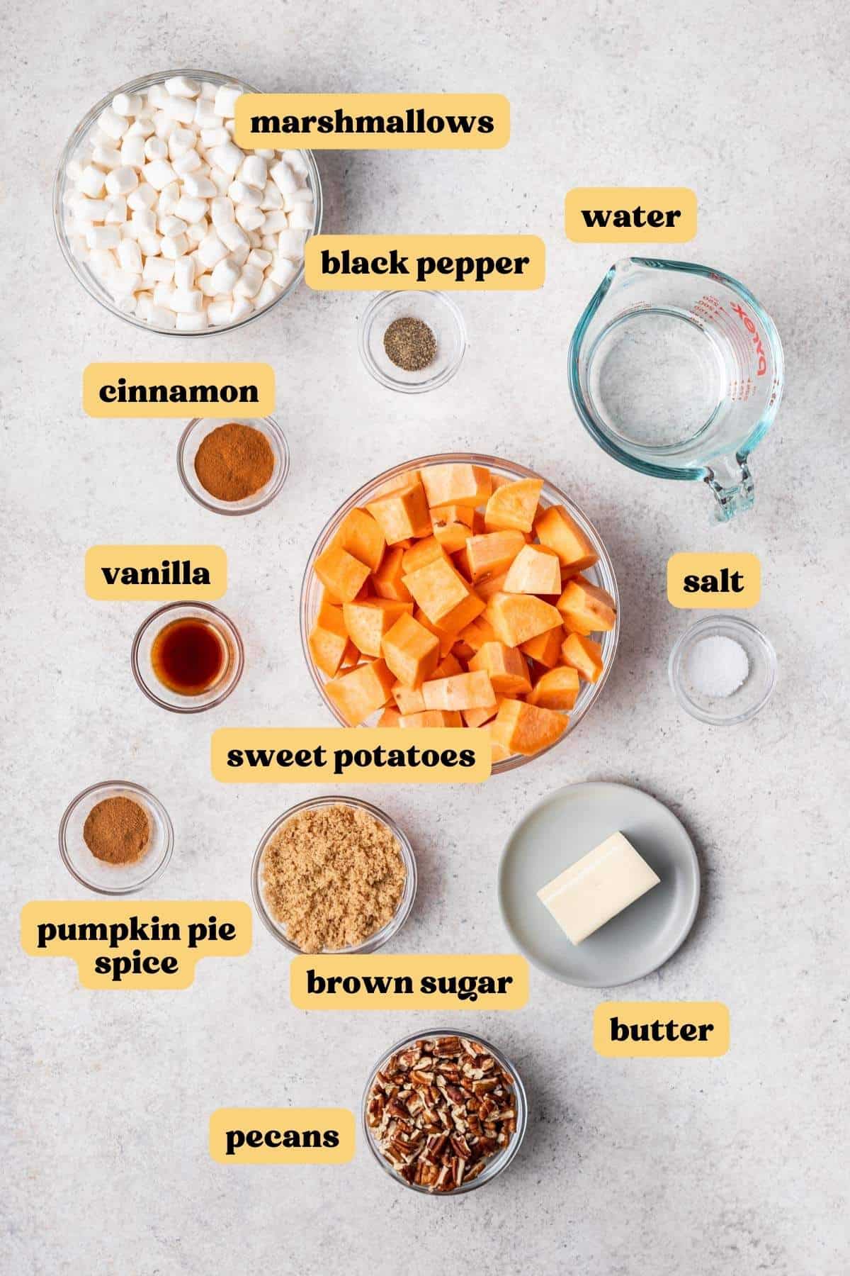 Ingredients you need for crockpot sweet potato casserole measured and labeled in individual mixing bowls.